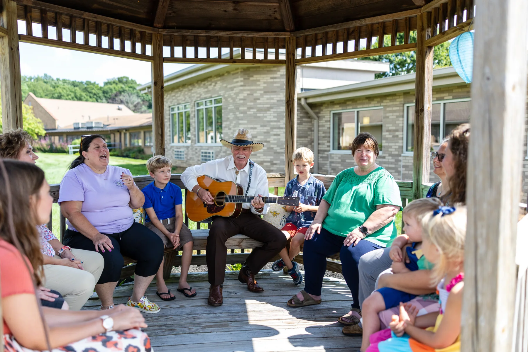 Members gathered for music and fellowship in a gazebo